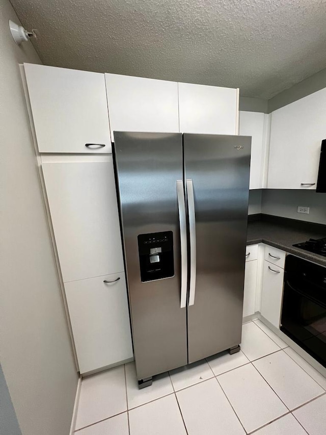 1720 Maple Ave Unit 670, Evanston, IL 60201 - kitchen with black appliances, dark countertops, white cabinetry, a textured ceiling, and light tile patterned floors