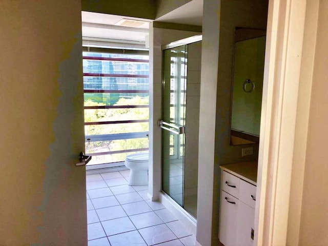 1720 Maple Ave Unit 670, Evanston, IL 60201 - bathroom with tile patterned flooring, toilet, a shower stall, and vanity