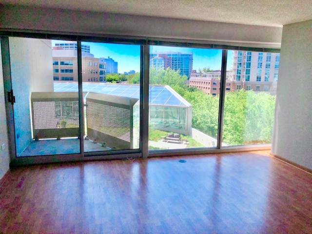 1720 Maple Ave Unit 670, Evanston, IL 60201 - unfurnished room featuring wood finished floors, baseboards, and a textured ceiling