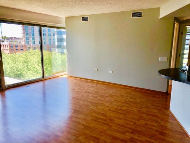 1720 Maple Ave Unit 670, Evanston, IL 60201 - unfurnished room featuring wood finished floors, a textured ceiling, and baseboards
