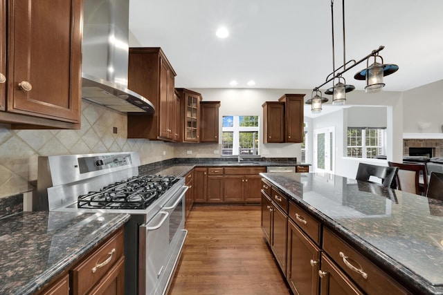 26809 Ashgate Xing, Plainfield, IL 60585 - kitchen with stainless steel range with gas cooktop, wall chimney range hood, dark wood-type flooring, glass insert cabinets, and a sink