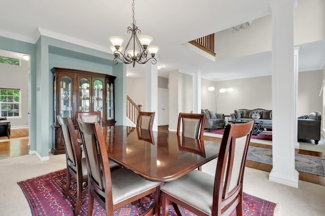 26809 Ashgate Xing, Plainfield, IL 60585 - dining space featuring a chandelier, light colored carpet, stairway, baseboards, and ornamental molding