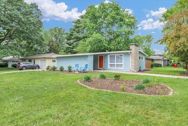 1602 Normandy Dr, Champaign, IL 61821 - view of front of home featuring a garage, a front lawn, and a chimney