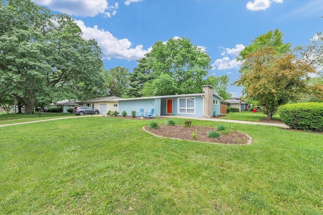 1602 Normandy Dr, Champaign, IL 61821 - view of front of house with a garage, a front yard, and a chimney