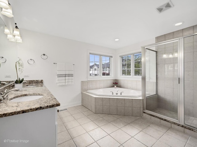 551 W 3rd St, Elmhurst, IL 60126 - full bathroom featuring tile patterned floors, double vanity, a bath, a shower stall, and recessed lighting