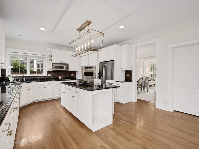 551 W 3rd St, Elmhurst, IL 60126 - kitchen with appliances with stainless steel finishes, light wood-type flooring, white cabinetry, backsplash, and recessed lighting