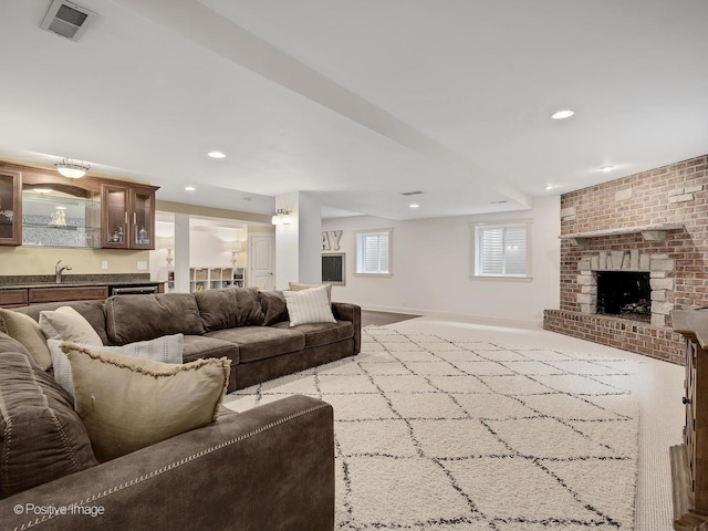 551 W 3rd St, Elmhurst, IL 60126 - carpeted living area with a brick fireplace, baseboards, recessed lighting, and bar