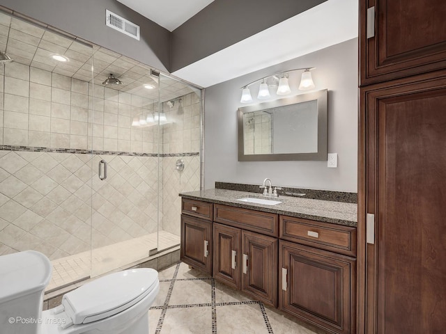 551 W 3rd St, Elmhurst, IL 60126 - bathroom featuring toilet, vanity, a stall shower, and tile patterned floors