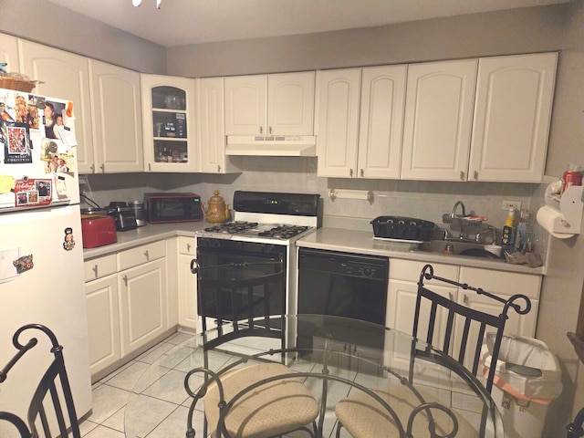 kitchen with freestanding refrigerator, range with gas stovetop, under cabinet range hood, dishwasher, and white cabinets