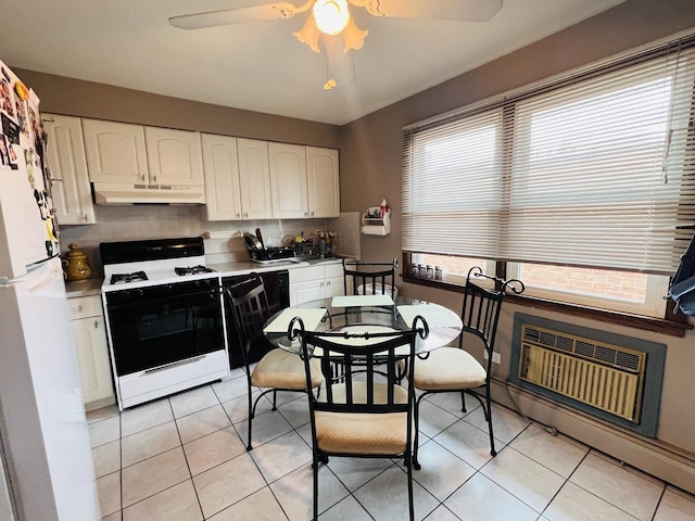 6968 W Diversey Ave Unit 7, Chicago, IL 60707 - kitchen featuring gas stove, under cabinet range hood, freestanding refrigerator, ceiling fan, and white cabinets