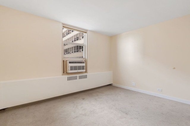 empty room with baseboards, cooling unit, and carpet