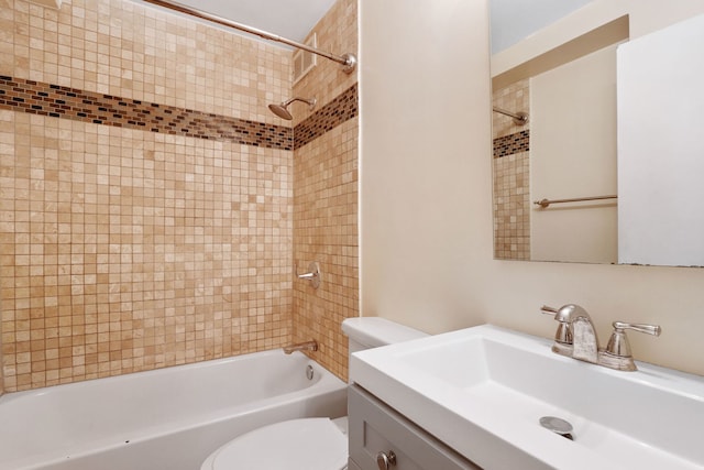 bathroom featuring toilet, tub / shower combination, and vanity