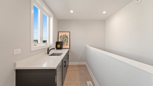 3124 S Benson St Unit 6, Chicago, IL 60608 - bar area featuring a sink, light wood-style floors, recessed lighting, and baseboards