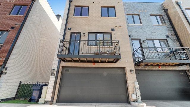 3124 S Benson St Unit 6, Chicago, IL 60608 - rear view of property with brick siding, an attached garage, a balcony, and driveway