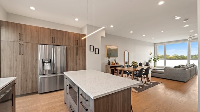 3124 S Benson St Unit 6, Chicago, IL 60608 - kitchen with appliances with stainless steel finishes, light wood finished floors, a kitchen island, open floor plan, and recessed lighting