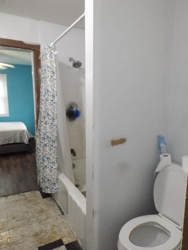bathroom with toilet and shower / bathtub combination with curtain