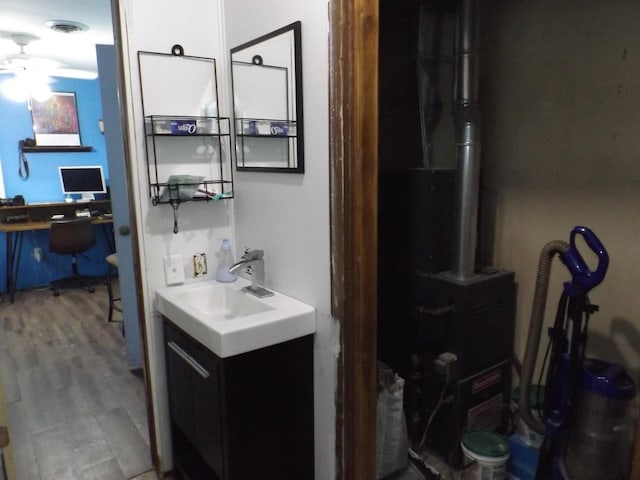bathroom featuring vanity, ceiling fan, and wood finished floors
