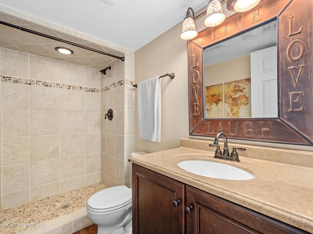 7235 Kiowa Ln, Palos Heights, IL 60463 - bathroom featuring vanity, tiled shower, and toilet