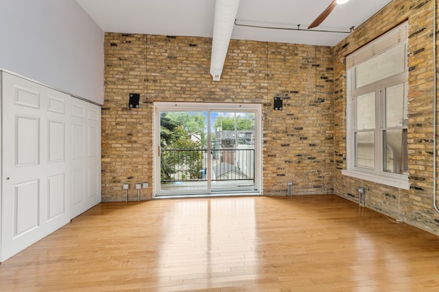 1012 W Diversey Pkwy Unit 2, Chicago, IL 60614 - unfurnished room with brick wall, wood finished floors, and ceiling fan