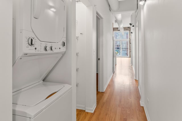 1012 W Diversey Pkwy Unit 2, Chicago, IL 60614 - washroom featuring stacked washer / drying machine, light wood-type flooring, and baseboards