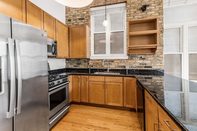 1012 W Diversey Pkwy Unit 2, Chicago, IL 60614 - kitchen with stainless steel appliances, a sink, brown cabinetry, and light wood finished floors