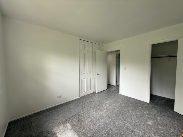 217 Davis Ln, Bolingbrook, IL 60440 - unfurnished bedroom featuring dark carpet and baseboards