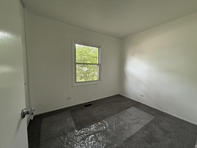 217 Davis Ln, Bolingbrook, IL 60440 - empty room featuring dark colored carpet and baseboards