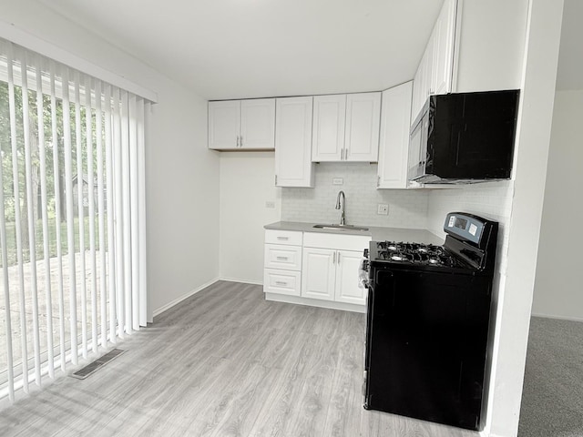 217 Davis Ln, Bolingbrook, IL 60440 - kitchen featuring range with gas stovetop, a sink, white cabinets, and backsplash