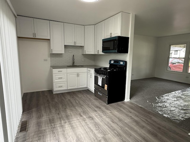 217 Davis Ln, Bolingbrook, IL 60440 - kitchen featuring black appliances, a sink, white cabinets, tasteful backsplash, and wood finished floors