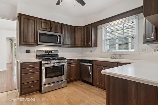 827 Forest Ave, River Forest, IL 60305 - kitchen with stainless steel appliances, ceiling fan, light countertops, light wood-style flooring, and dark brown cabinetry