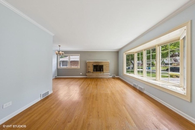 10 N Waverly Pl, Mount Prospect, IL 60056 - unfurnished living room featuring a chandelier, light wood finished floors, a fireplace, ornamental molding, and baseboards