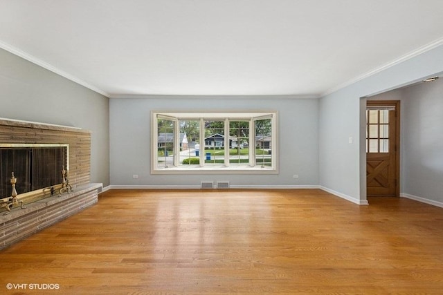 10 N Waverly Pl, Mount Prospect, IL 60056 - unfurnished living room with light wood-style floors, ornamental molding, baseboards, and a brick fireplace