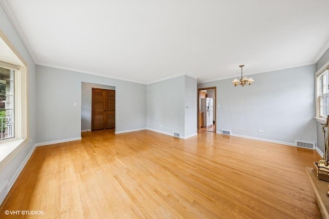 10 N Waverly Pl, Mount Prospect, IL 60056 - unfurnished living room with a chandelier, crown molding, light wood-style flooring, and baseboards