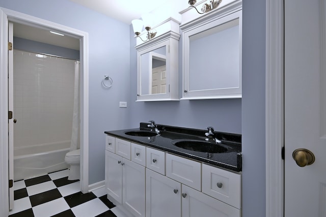 bathroom featuring double vanity, tile patterned floors, toilet, and shower / bath combo