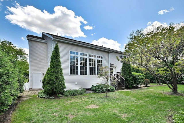 view of side of home with a yard