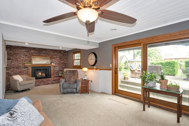 623 Woodstock Ln, Bourbonnais, IL 60914 - living room with carpet, a fireplace, a wainscoted wall, and ceiling fan