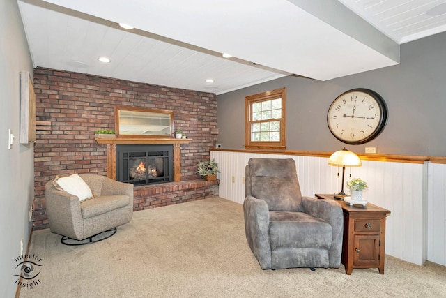 623 Woodstock Ln, Bourbonnais, IL 60914 - living room featuring carpet flooring, a wainscoted wall, and a fireplace
