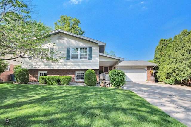 623 Woodstock Ln, Bourbonnais, IL 60914 - split level home featuring brick siding, an attached garage, a front lawn, and driveway