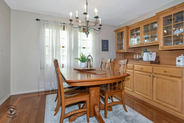 623 Woodstock Ln, Bourbonnais, IL 60914 - dining area with a chandelier, wood finished floors, and baseboards
