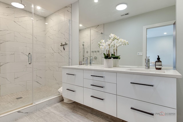 2860 N Milwaukee Ave Unit 2S, Chicago, IL 60618 - full bathroom with marble finish floors, a stall shower, double vanity, recessed lighting, and toilet
