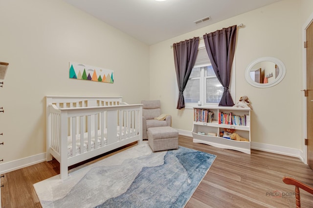 2860 N Milwaukee Ave Unit 2S, Chicago, IL 60618 - bedroom featuring wood finished floors, baseboards, and a nursery area