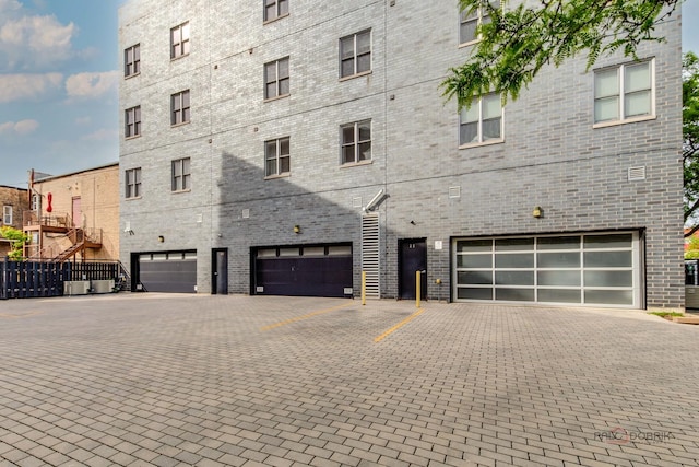 2860 N Milwaukee Ave Unit 2S, Chicago, IL 60618 - view of property featuring an attached garage and driveway