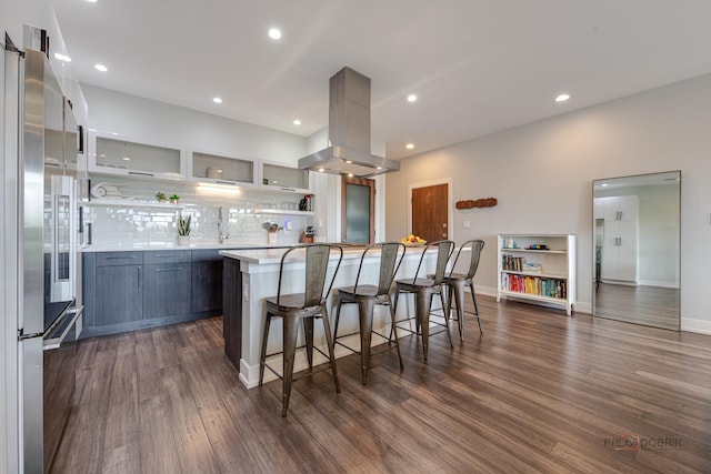 2860 N Milwaukee Ave Unit 2S, Chicago, IL 60618 - kitchen with island exhaust hood, high end fridge, light countertops, open shelves, and a breakfast bar