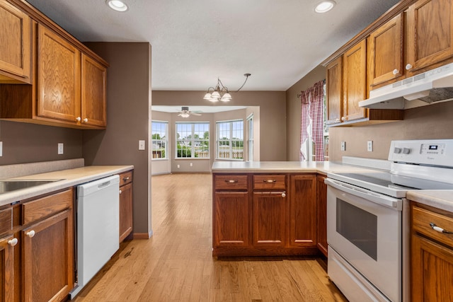 610 Chestnut Dr, Saint Joseph, IL 61873 - kitchen featuring white appliances, a peninsula, brown cabinetry, and recessed lighting
