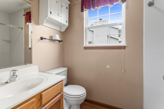 610 Chestnut Dr, Saint Joseph, IL 61873 - bathroom featuring toilet, vanity, a shower, and wood finished floors