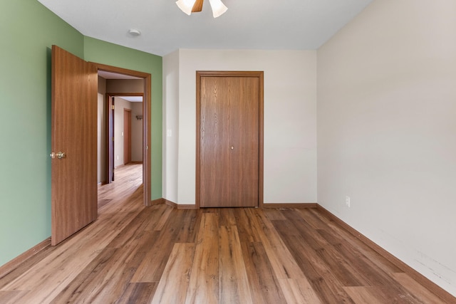 610 Chestnut Dr, Saint Joseph, IL 61873 - unfurnished bedroom featuring a closet, wood finished floors, and baseboards