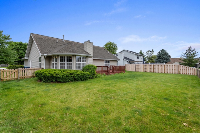 610 Chestnut Dr, Saint Joseph, IL 61873 - rear view of house featuring a chimney, a shingled roof, and a wooden deck