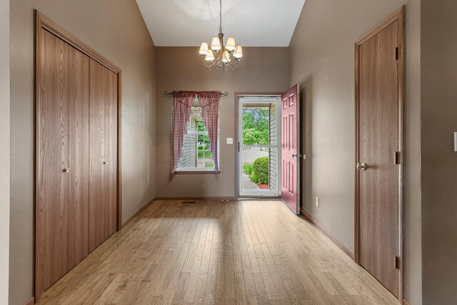 610 Chestnut Dr, Saint Joseph, IL 61873 - entrance foyer featuring light wood-type flooring and a chandelier