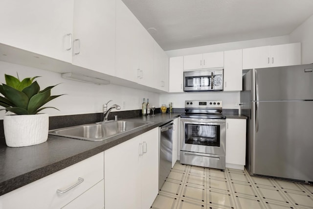 405 N Wabash Ave Unit 1002, Chicago, IL 60611 - kitchen featuring stainless steel appliances, a sink, light floors, white cabinets, and dark countertops