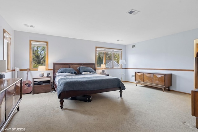 carpeted bedroom with multiple windows and baseboards